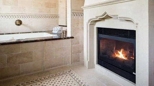Fireplace and tub at Roman Spa