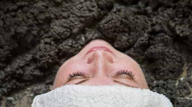 Woman soaks in mud bath