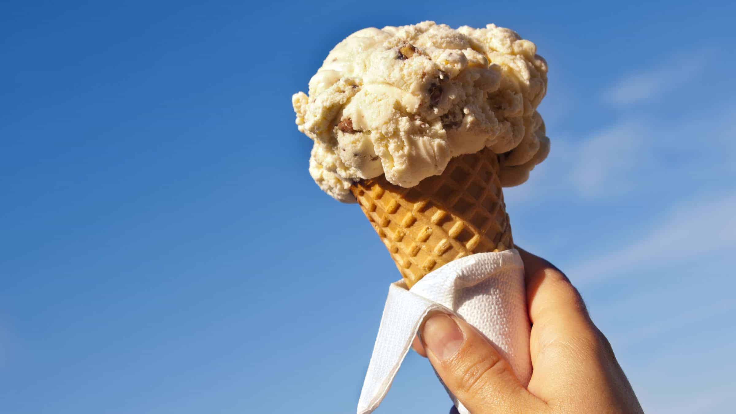 photo of hand holding ice cream cone