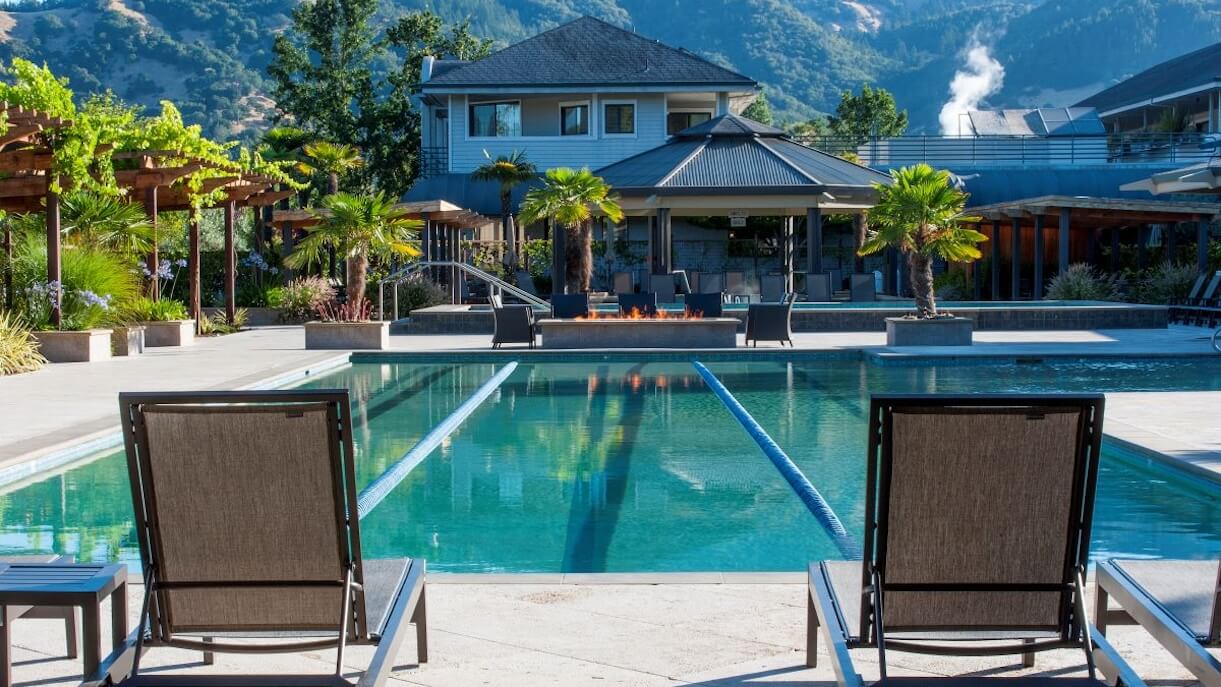 shot of pool at calistoga hot springs from behind sun chairs with hotel in the background