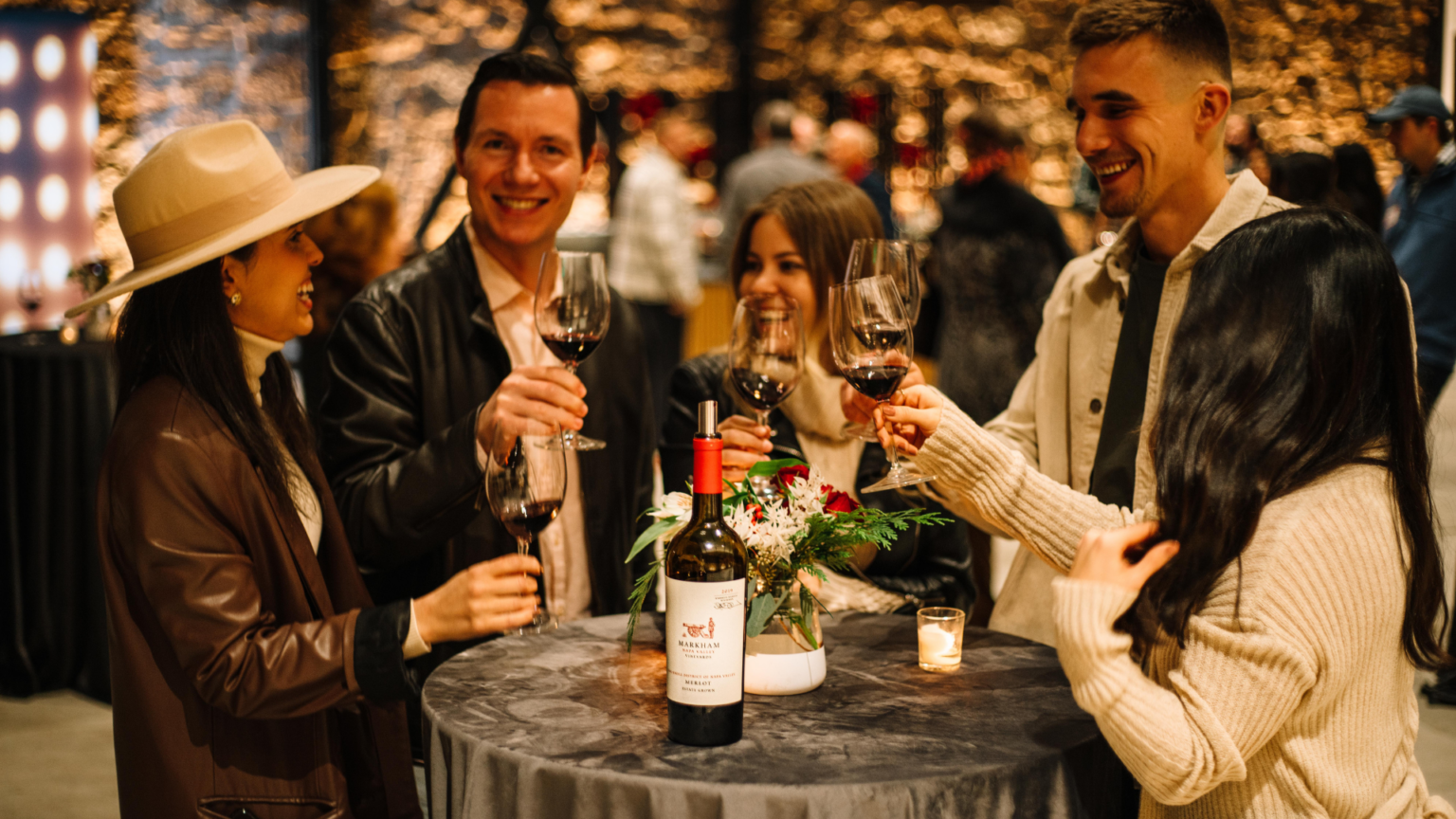 people toasting wine and smiling