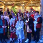 group of people dressed in christmas clothes outside