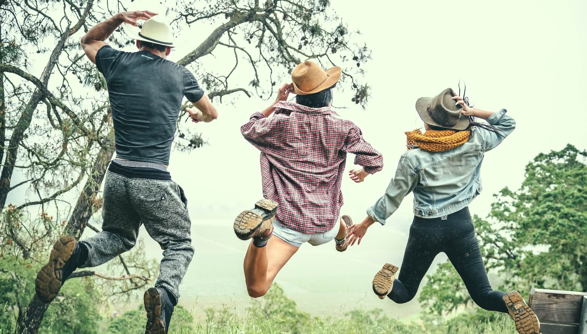 3 friends jumping in vineyards