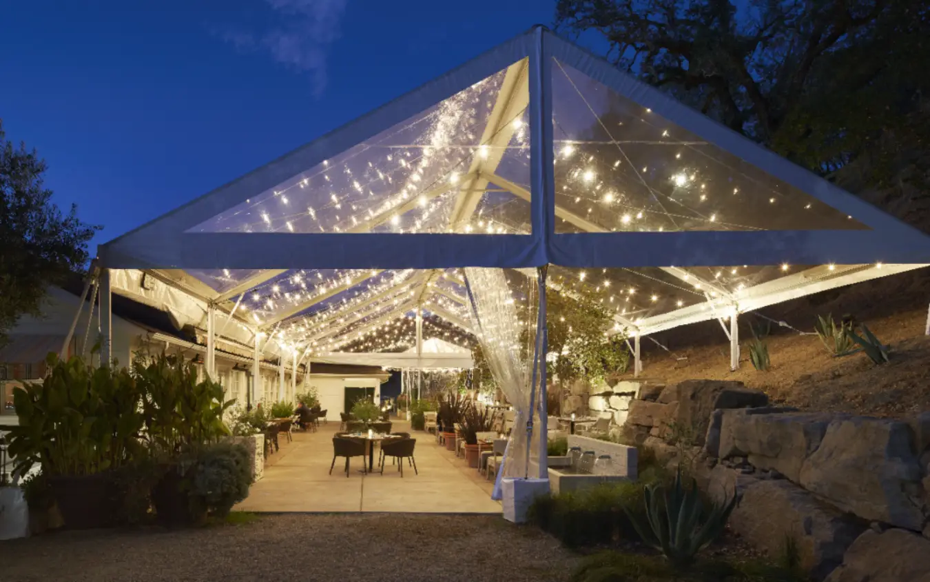 tent placed outside for event with lots of lights
