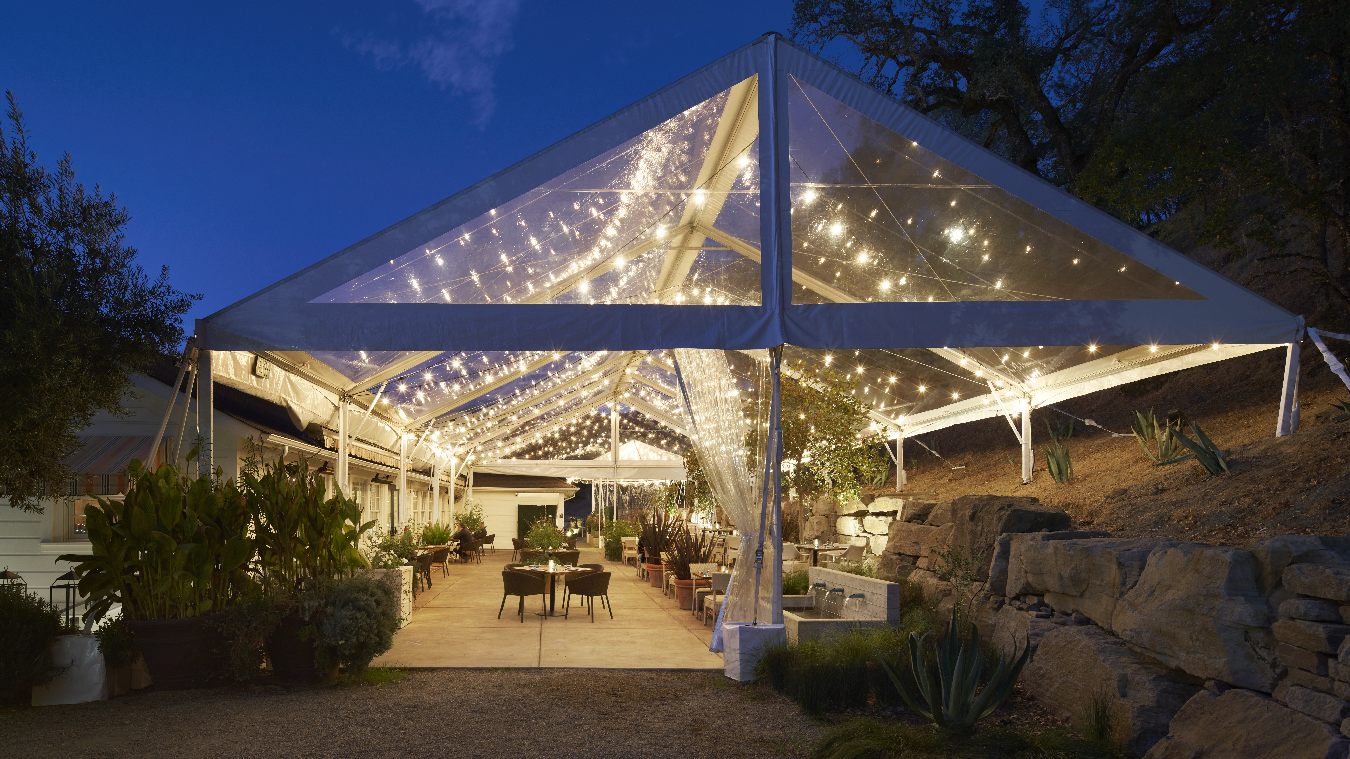 tent placed outside for event with lots of lights