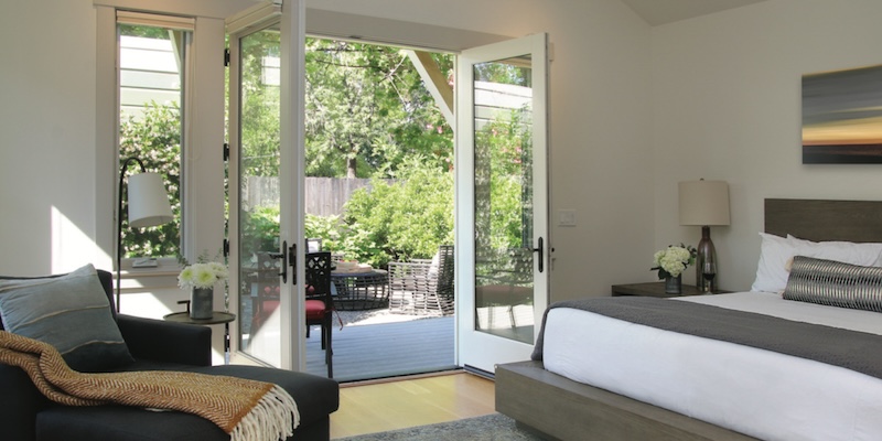 hotel room with bed and furniture and door