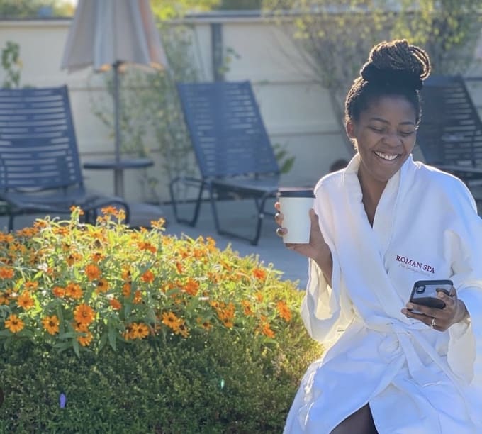 woman holding cup of coffee in outside garden