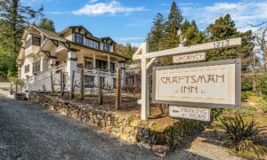 craftsman inn entrance and sign, with lodge on the back