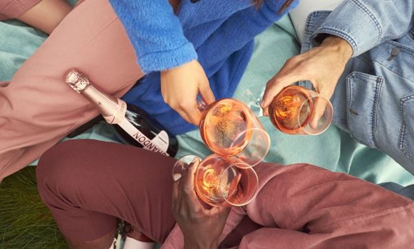 view from above of glasses cheersing with wine