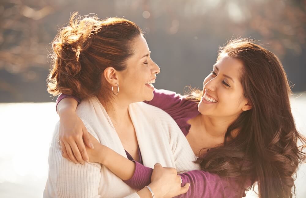mother and daughter hugging and laughing