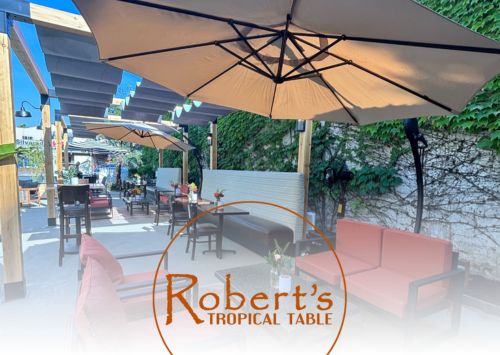 robert's tropical table seating area with logo