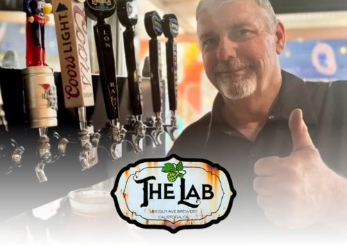 man giving thumbs up by beer taps with The L.A.B. logo