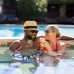 couple relaxing with drinks inside hot tub