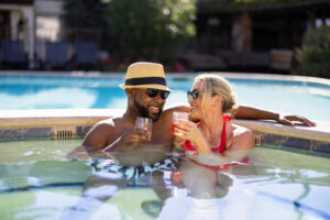couple relaxing with drinks inside hot tub
