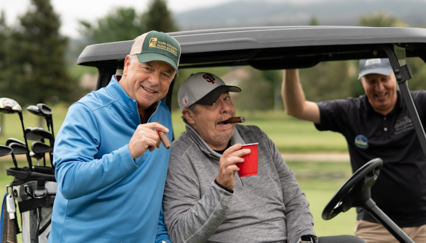friends in golf cart at cinco de mayo golf inc