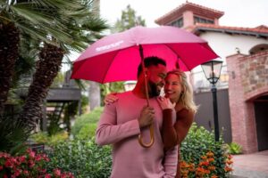 couple looking at each other lovingly under umbrella at roman spa hot springs