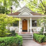 cute white house surrounded by trees